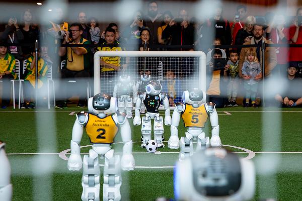 Robot Soccer Players Move the Ball, and Technology, Forward